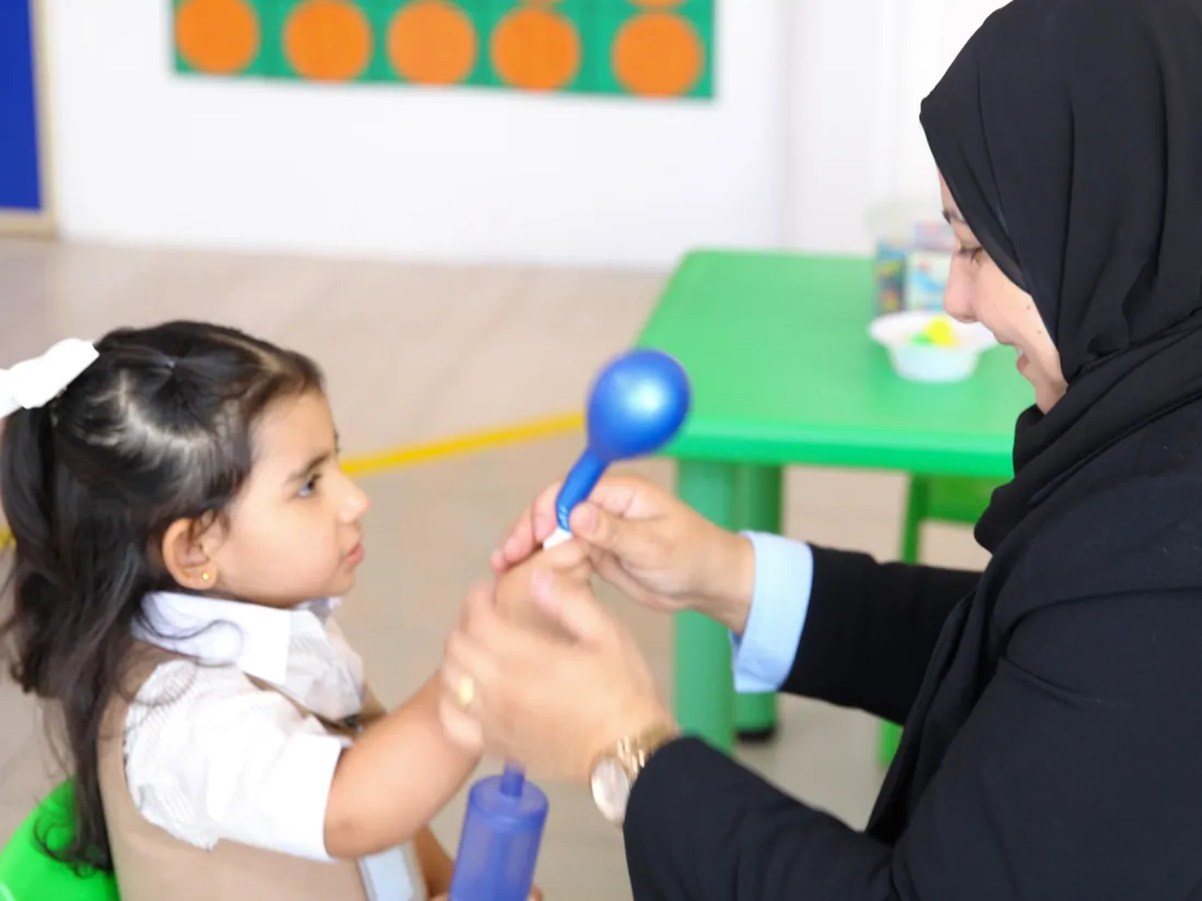 An AFS teacher sharing a warm one-on-one moment with a young pupil