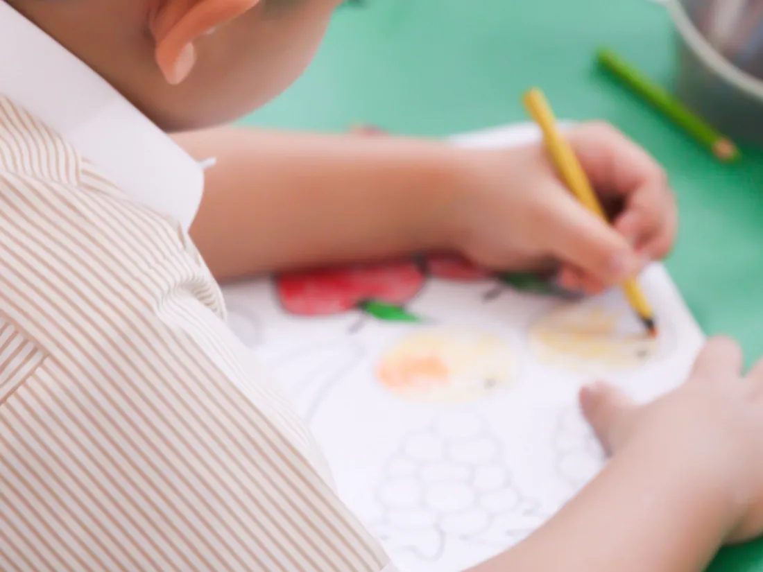 An AFS pupil working carefully through a colouring worksheet