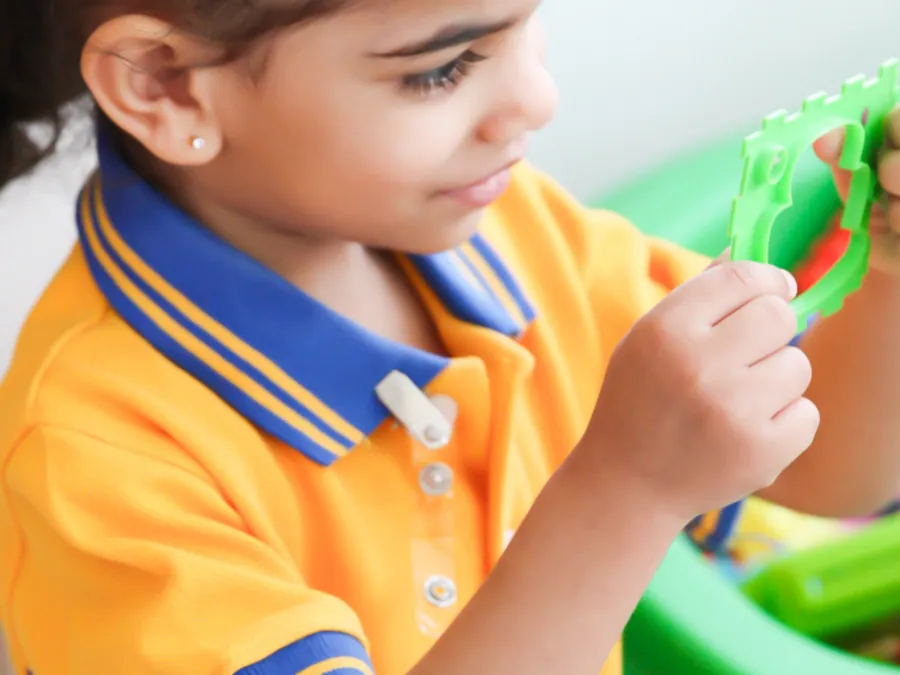 A young pupil playing with a toy at an activity table